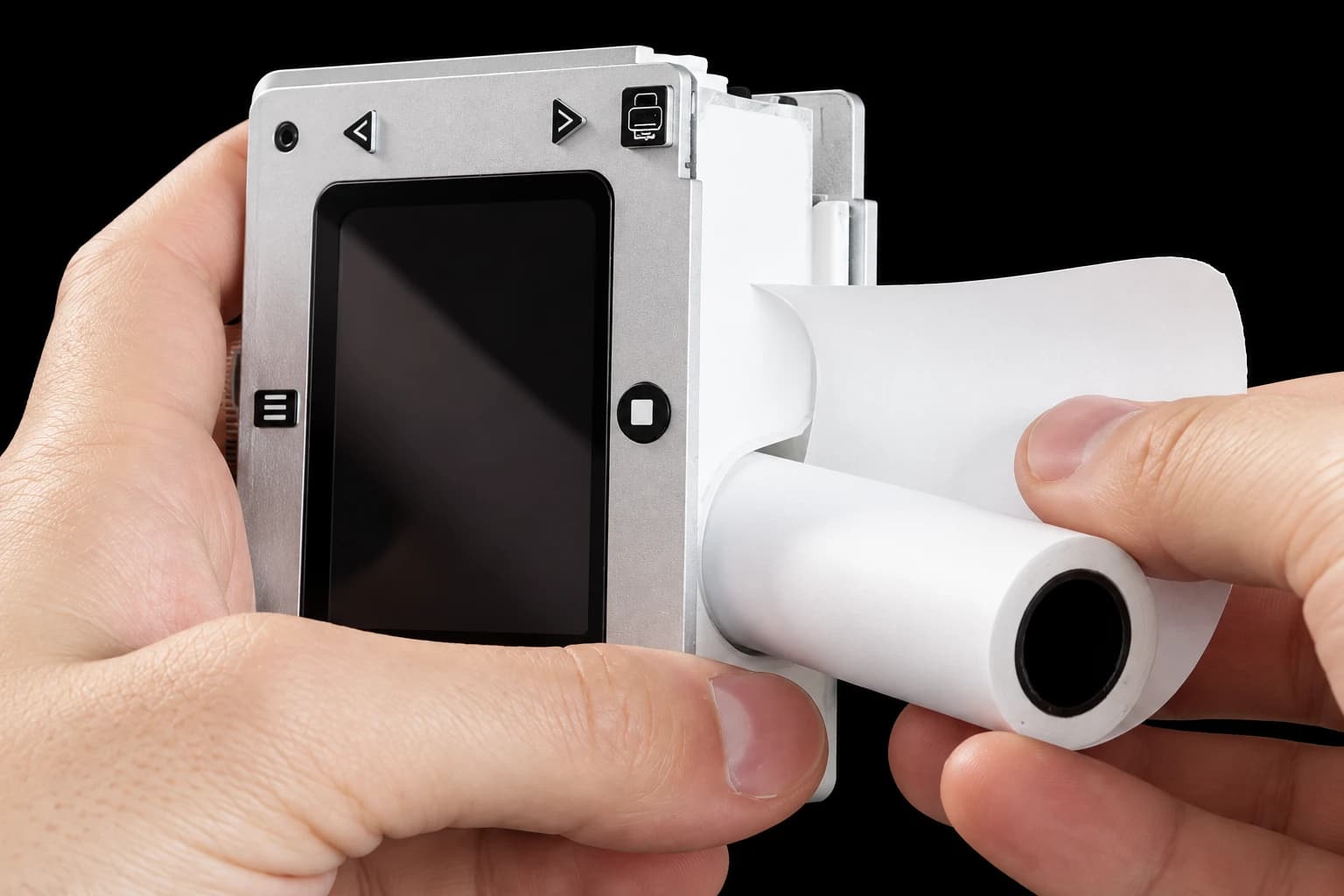 Studio-enhanced view of the opened Sticker Camera with a paper roll being loaded